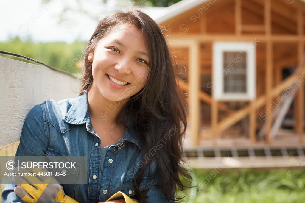 A young woman on a traditional farm in the countryside of New York State, USA. Woodstock, New York, USA. 7/4/2012