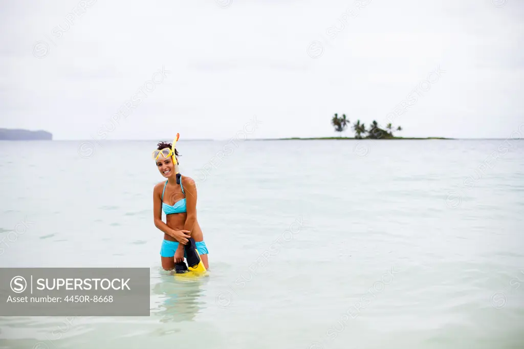 A young woman wades in shallow water on the Samana Peninsula in the Dominican Republic. Samana Peninsula, Dominican Republic. 4/6/2011