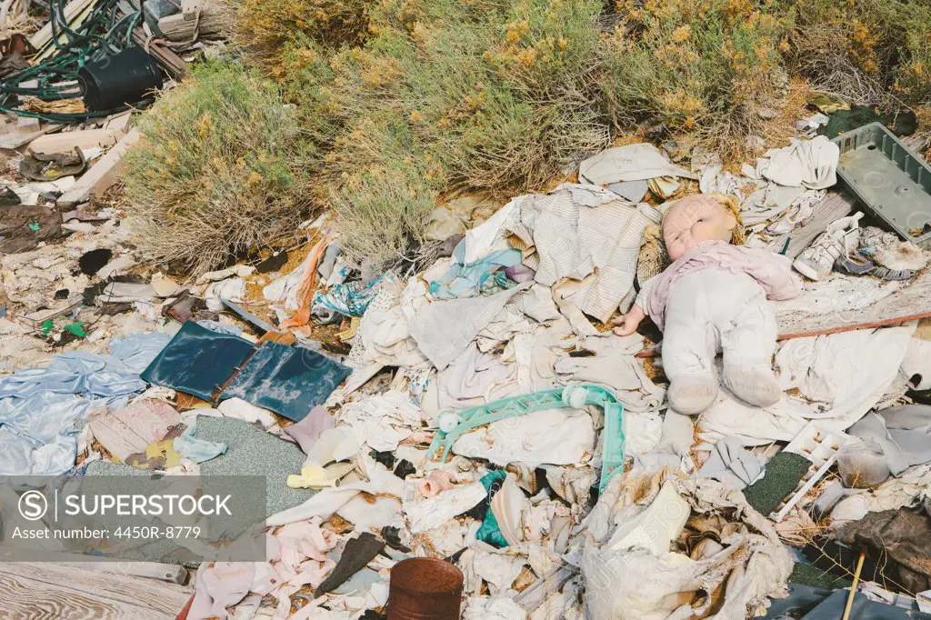 A heap of garbage and discarded items. Rubbish, paper and a children's doll.  8/12/2012