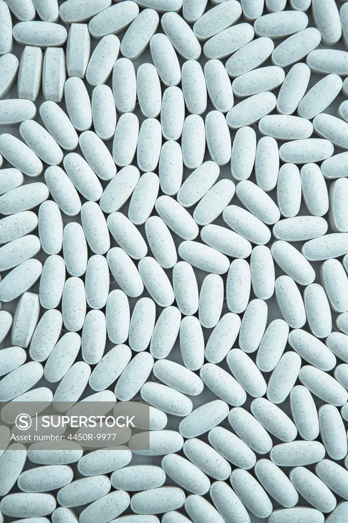 Vitamin C supplements, small blue oval tablets. King County, Washington, USA