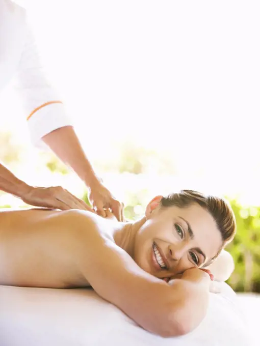 Smiling Woman receiving massage therapy at a luxury resort and spa in California