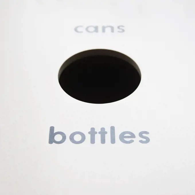 A recycling bin for bottles and cans. 