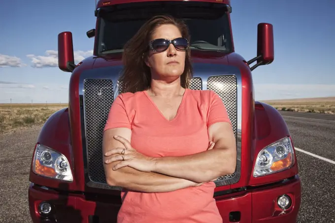 Portrait of a Caucasian woman driver and her  commercial truck.