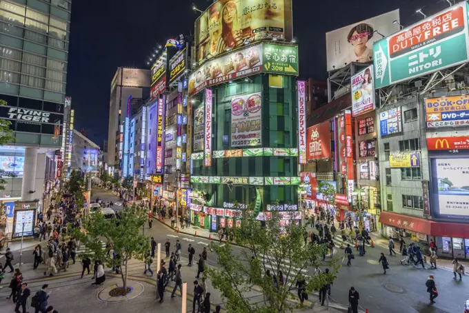 Street view with illuminated advertising boards at night, Shinjuku, Tokyo, Japan.