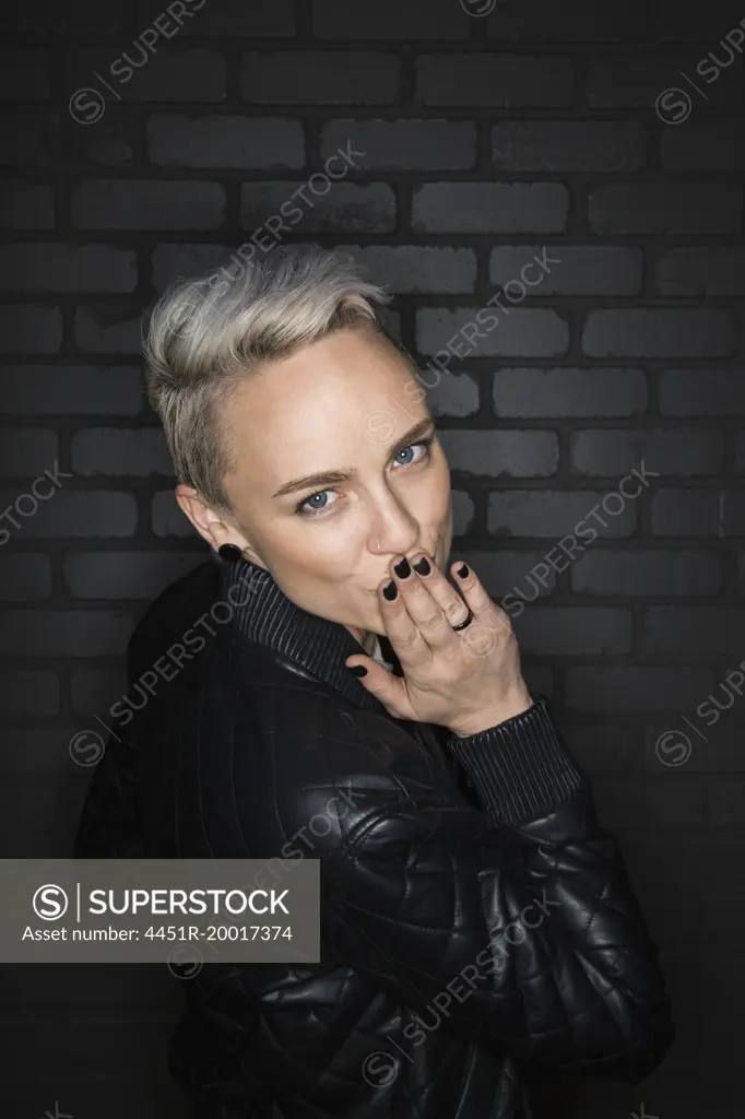 Portrait of blonde woman blowing a kiss