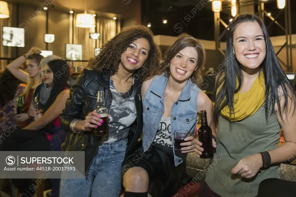 Portrait of smiling women drinking at bar
