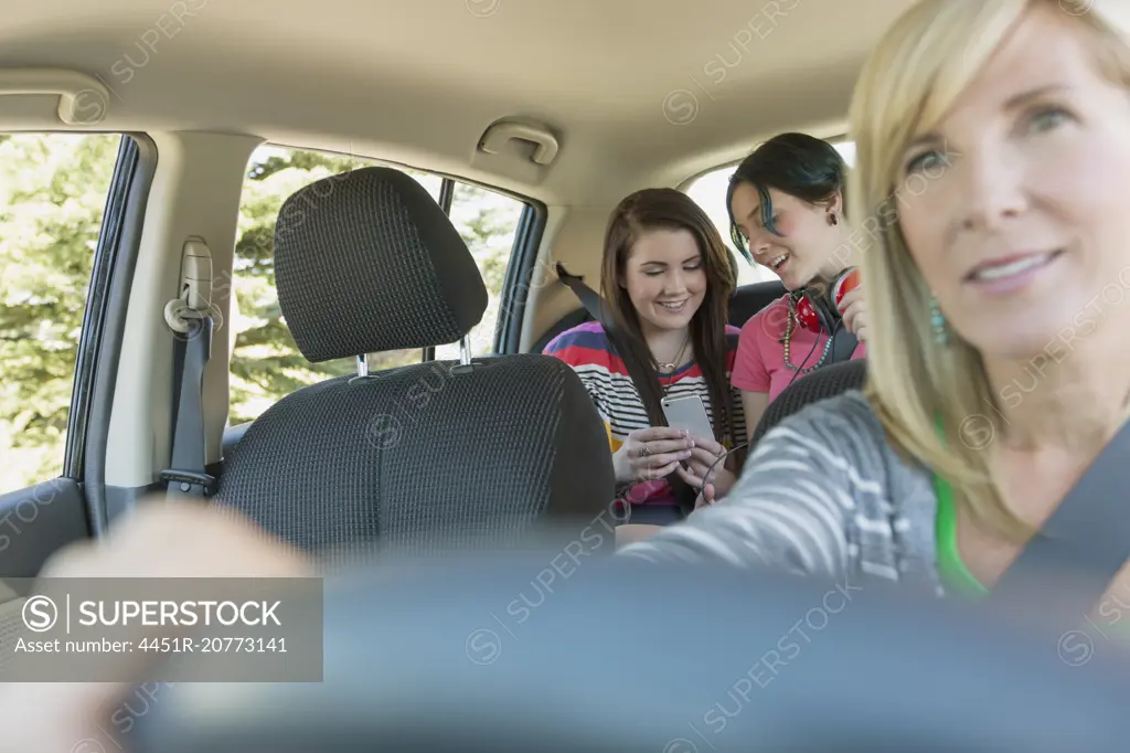 mother driving with teenage girls in the backseat