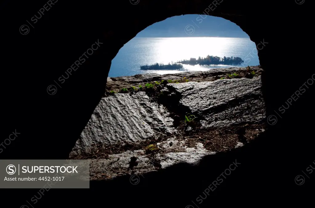 Brissago Islands Seen Through and Wall with an Arch in a Sunny Day in Ticino, Switzerland.