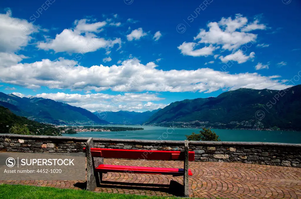 Bench with Panoramic View over Alpine Lake Maggiore with Mountain in Ronco sopra Ascona, Switzerland.
