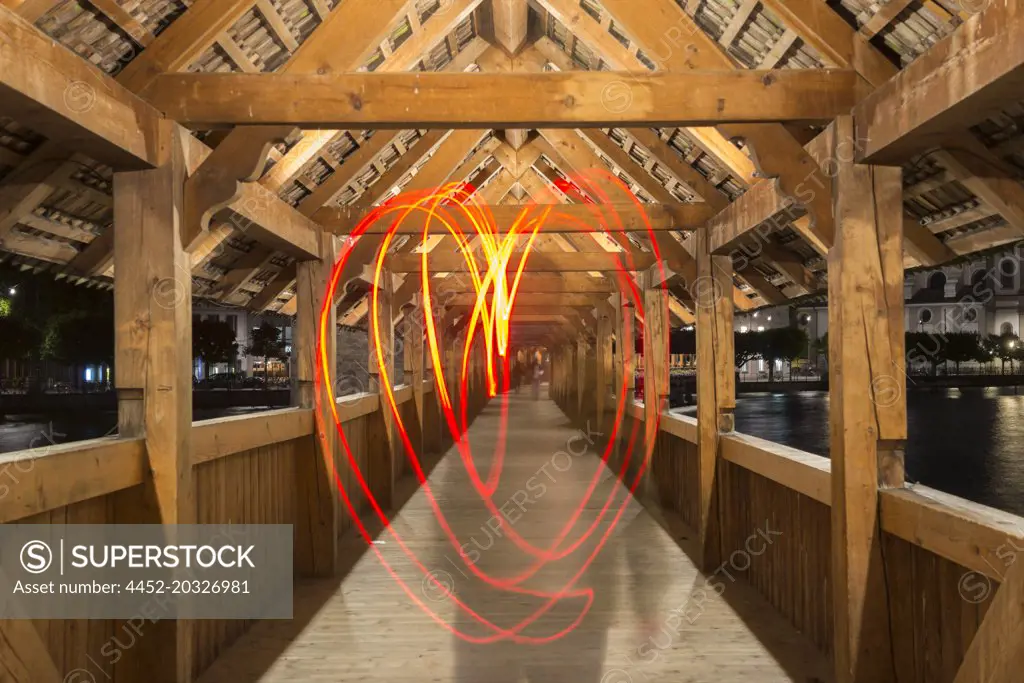 Light Painting a Heart Shape Inside Chapel Bridge at Night in Lucerne, Switzerland.