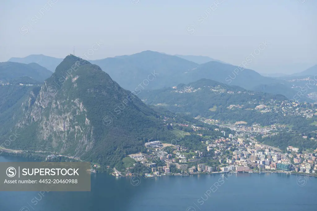 Panoramic View over City of Lugano and Mountain Peak with Alpine Lake in Ticino, Switzerland.