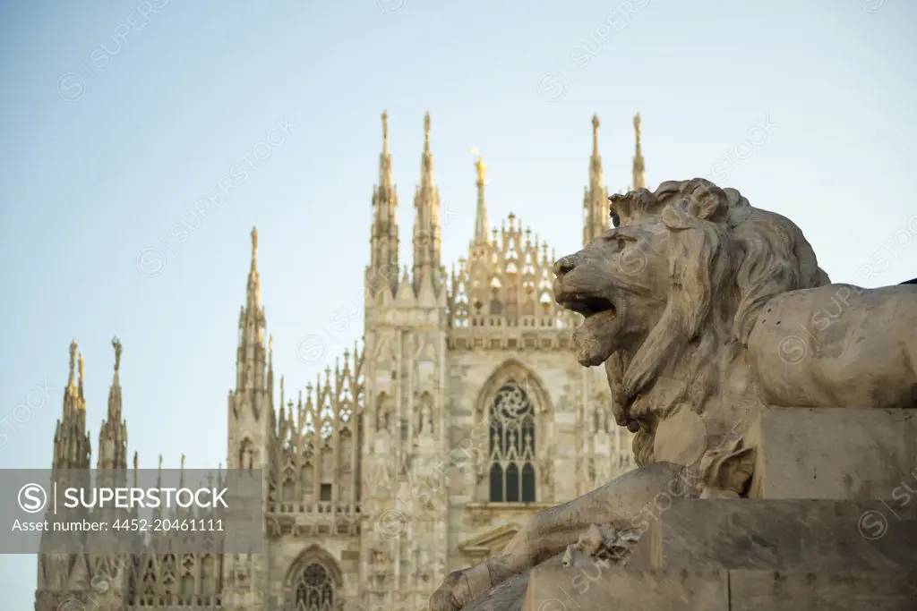 Milan Cathedral and Lion Statue with Sunlight in Lombardy, Italy.
