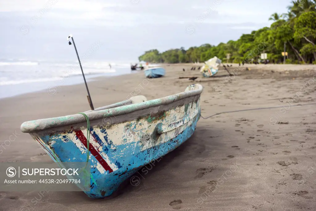 Footprints and boat on tropical beach