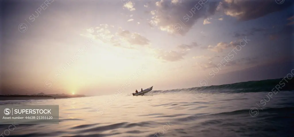 boat in ocean at sunset