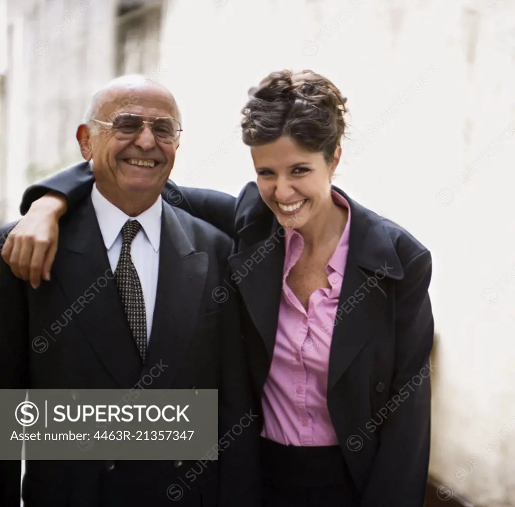 Portrait of an elderly businessman man with a young woman.