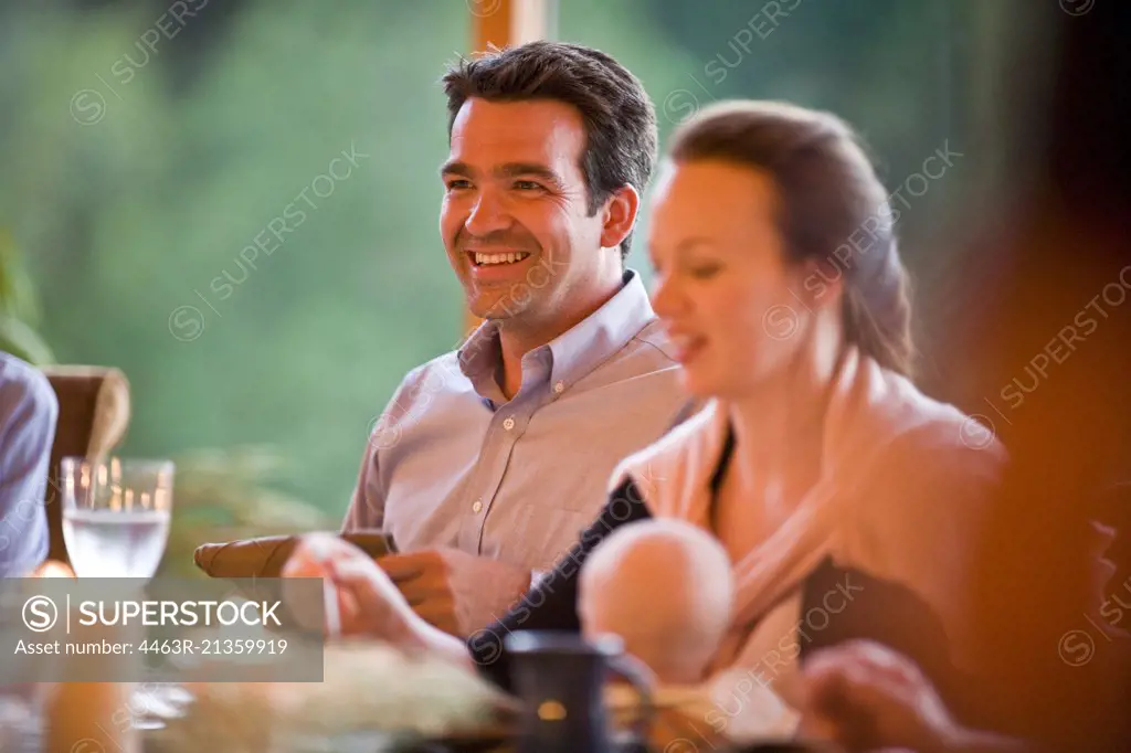 Man and woman with baby at dinner table