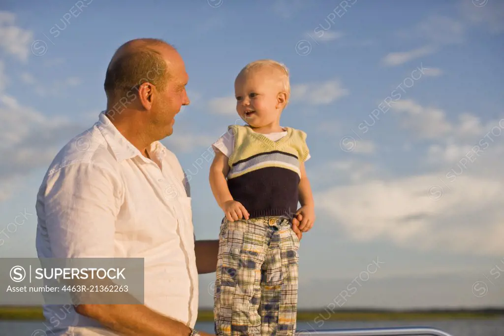 Smiling young toddler with his father.