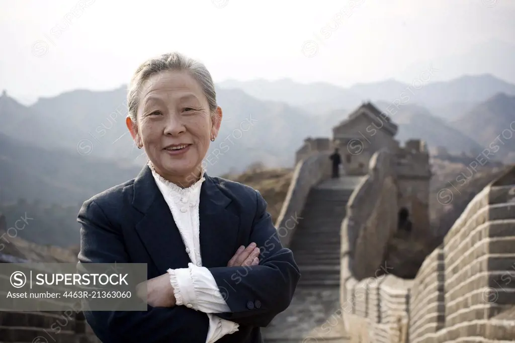 Portrait of a senior business woman standing on the Great Wall of China.