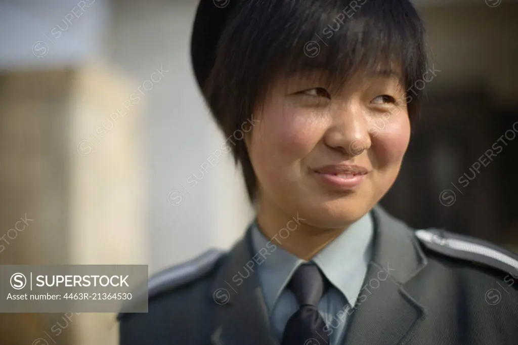 Portrait of young woman wearing uniform