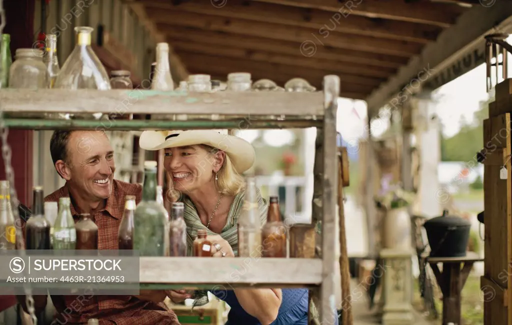 Smiling mature couple have fun shopping at the antique store together.