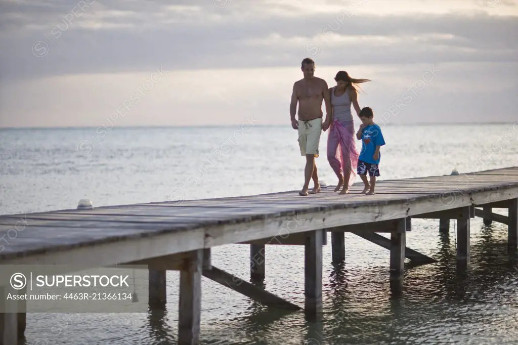 Family walking along a pier