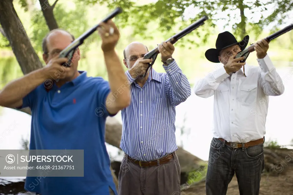 Men aiming rifles upwards