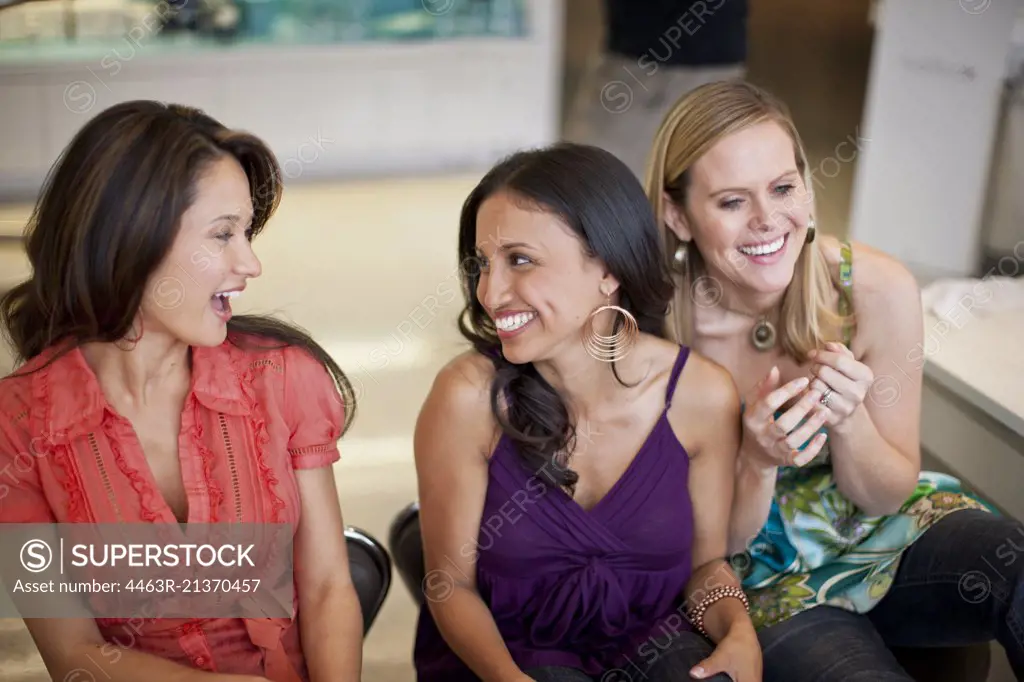 Three smiling women at a beauty salon.