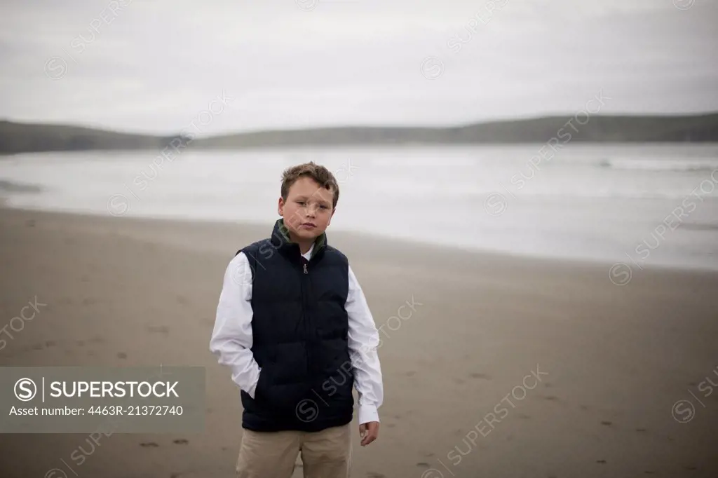 Boy standing on beach.