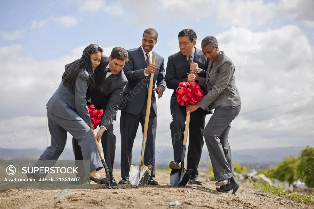 Group of business colleagues breaking ground on a project.