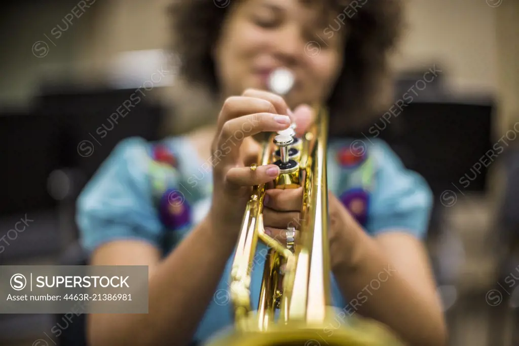 Young woman playing musical instrument.