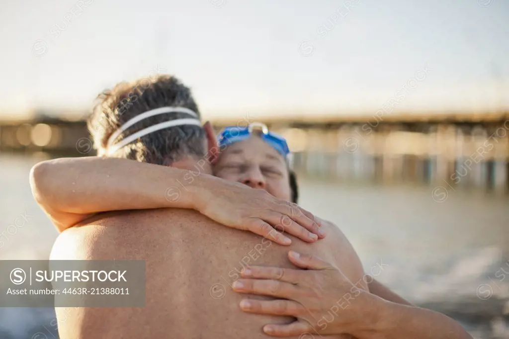 Mid adult couple hugging each other at the beach.