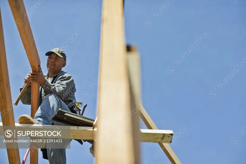 Builder cutting a piece of wood with a circular saw.