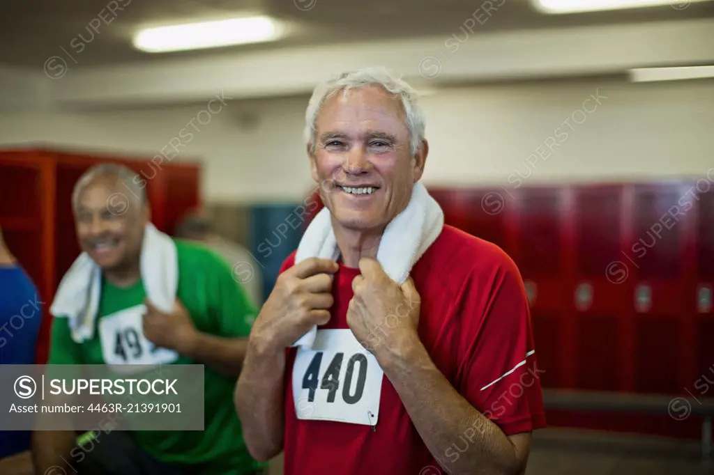 Portrait of a smiling senior man in a locker room.