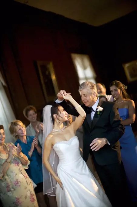 Young bride dancing with her father on her wedding day.