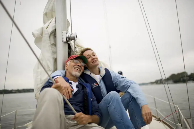 Mature couple relaxing on a sail boat.
