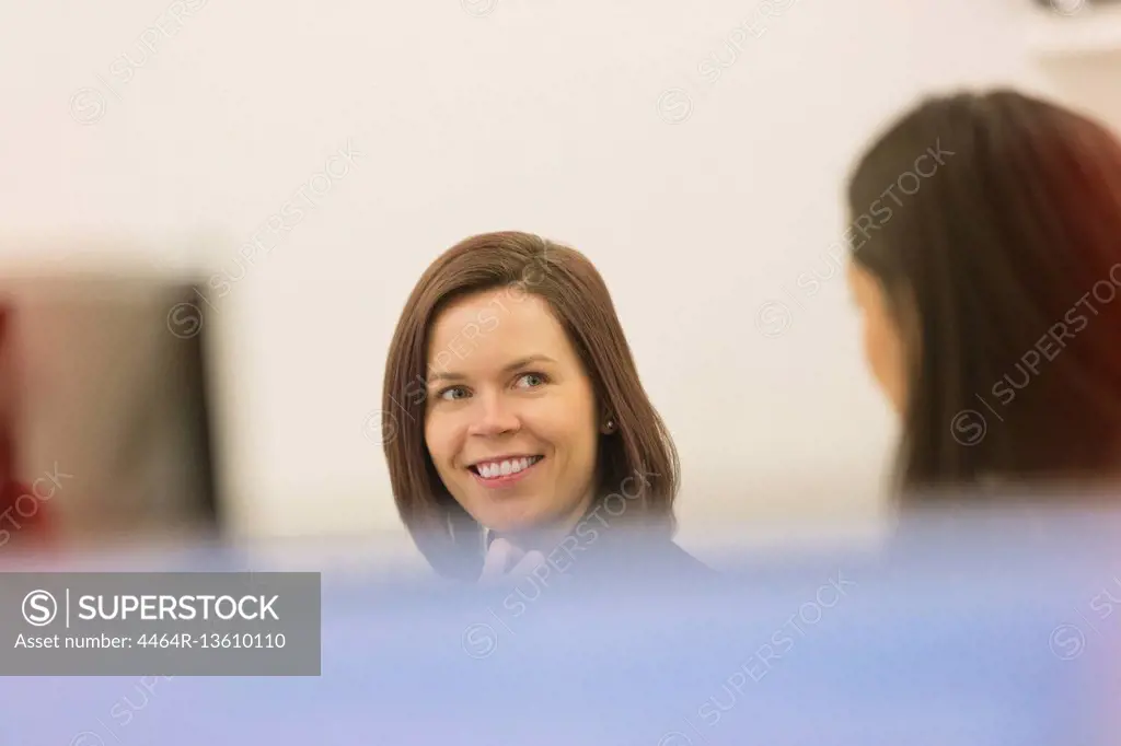 Smiling businesswomen talking in office