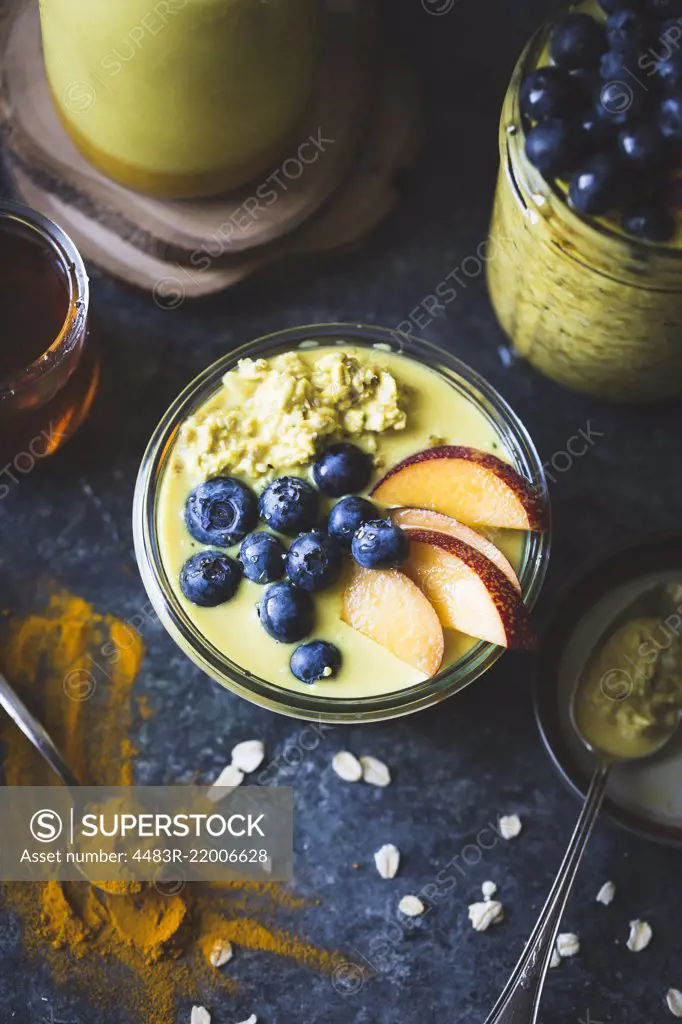 Healthy Golden milk overnight oats for breakfast with fresh fruits gluten-free)