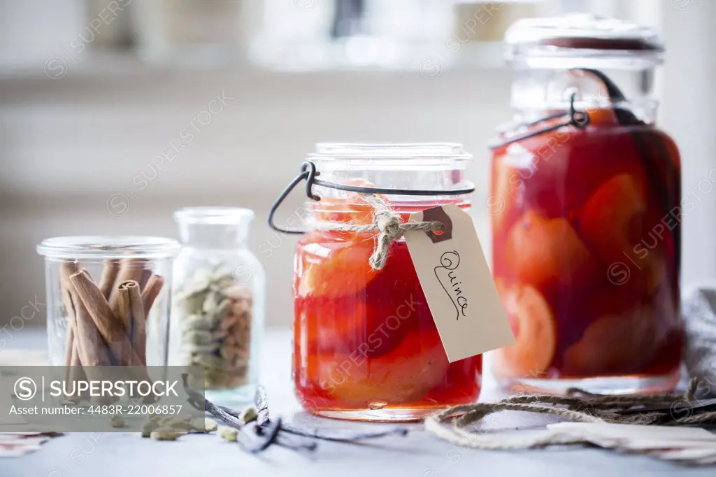 Poached Quince Fruit in a preserving mason jar.