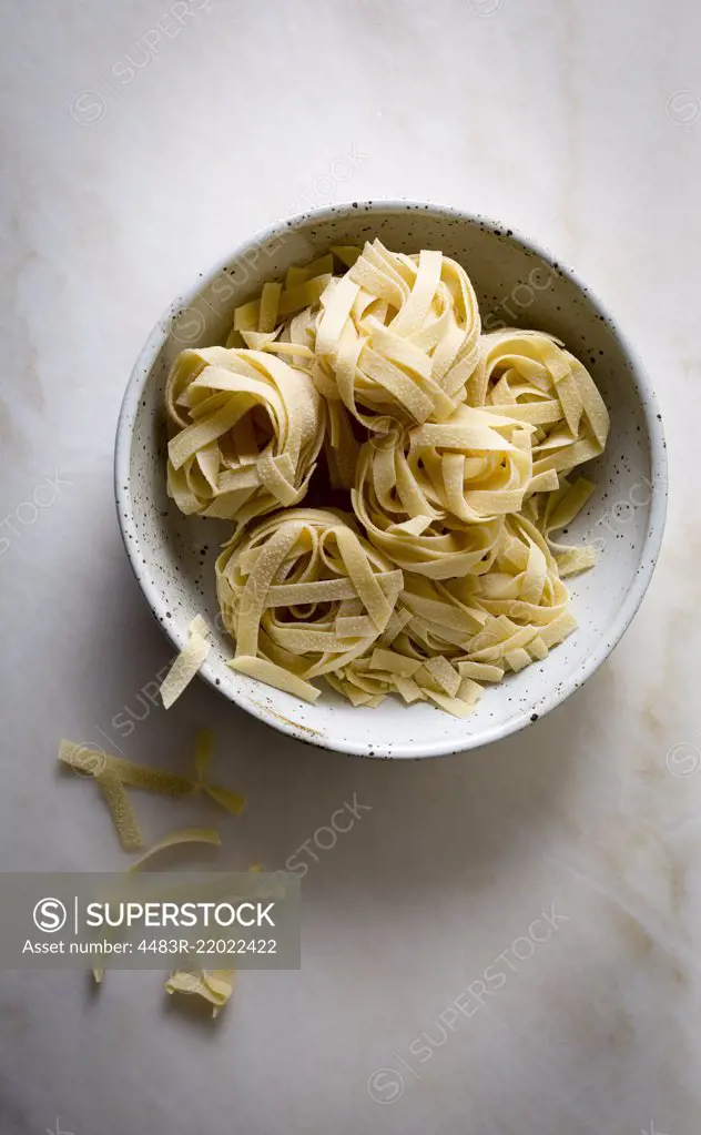 Raw pasta in a ceramic bowl
