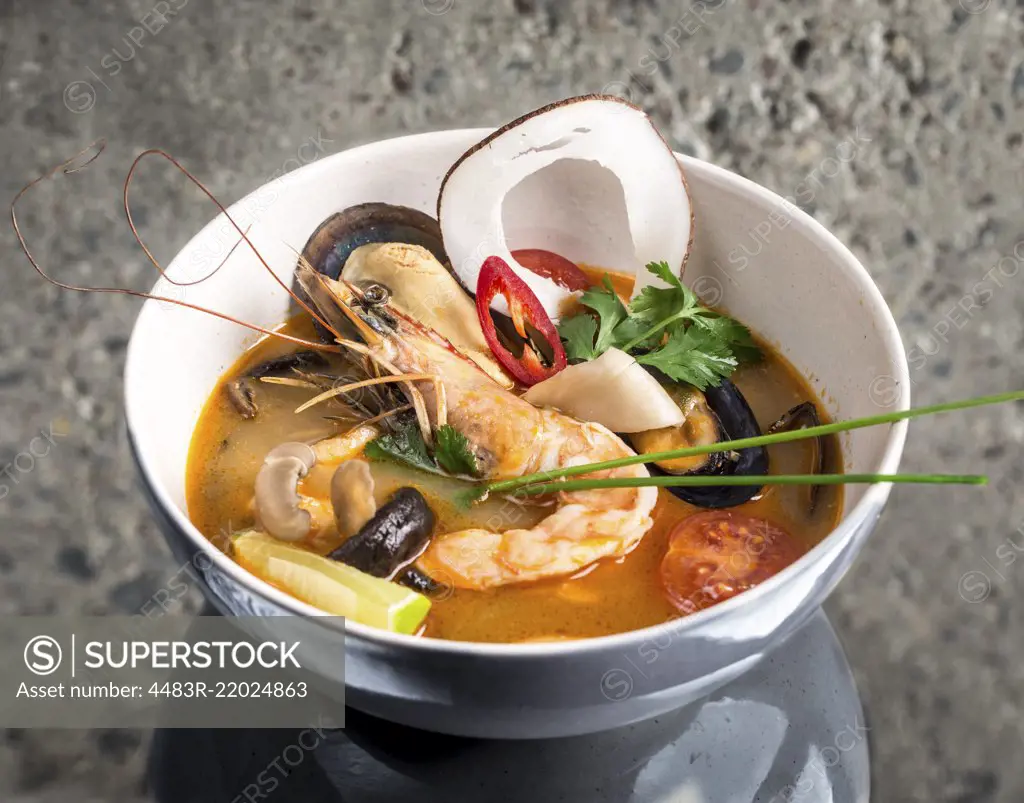 Tom Yum Goong thai soup over concrete background