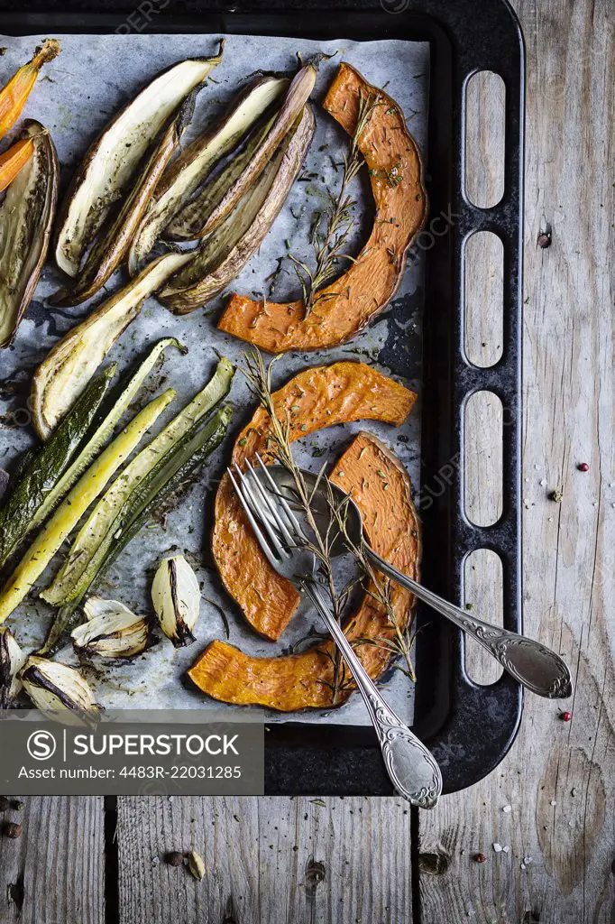 Roasted fresh vegetables on baking sheet. Top view