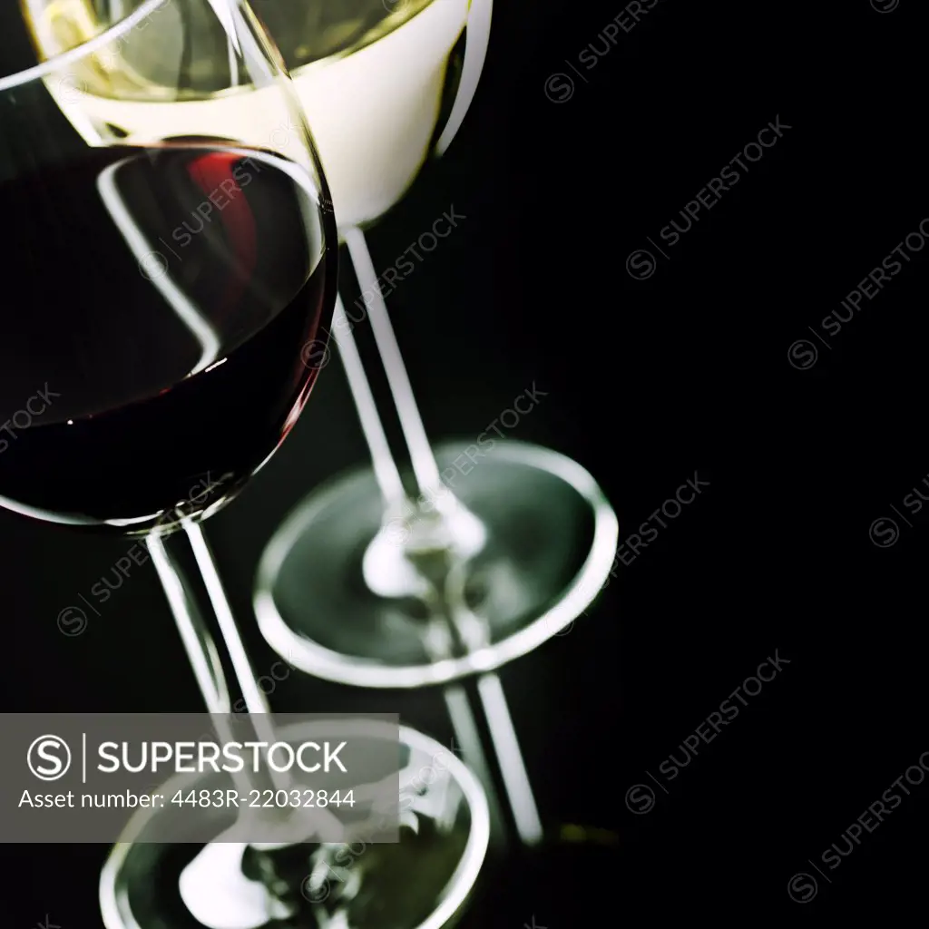 Glasses of wine on black background