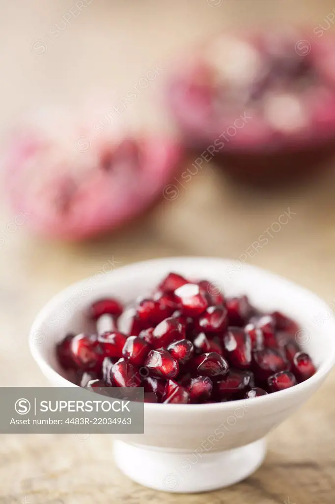 Pomegranate Seeds in White Bowl