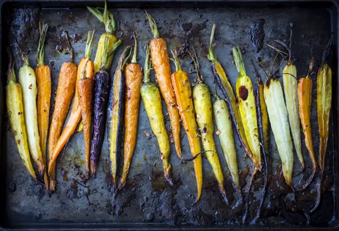 Rainbow carrots roasted on a pan.