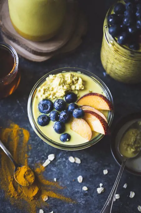 Healthy Golden milk overnight oats for breakfast with fresh fruits gluten-free)