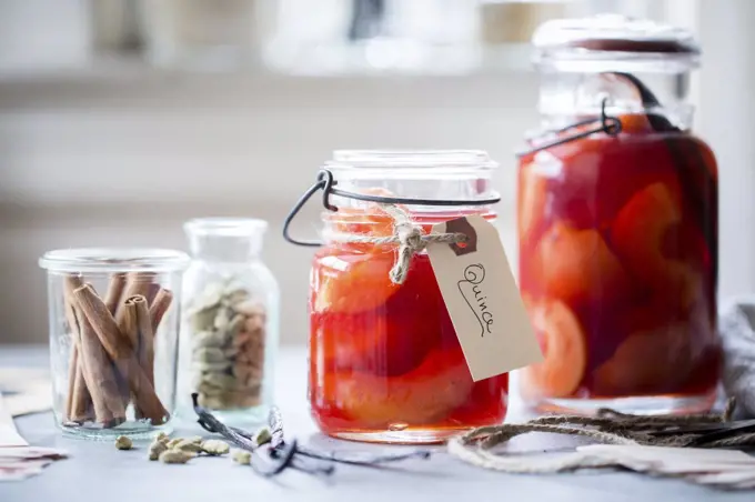 Poached Quince Fruit in a preserving mason jar.