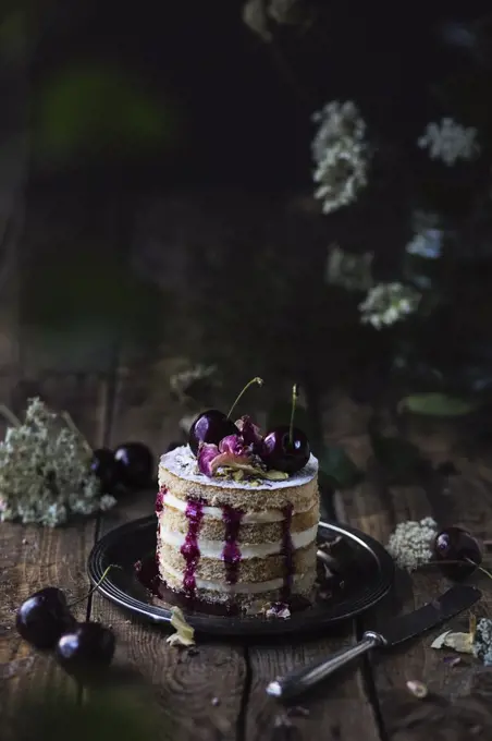 Black cherry cake on wooden table