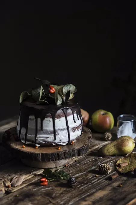 Autumn mood: chocolate & pear cake on wooden table