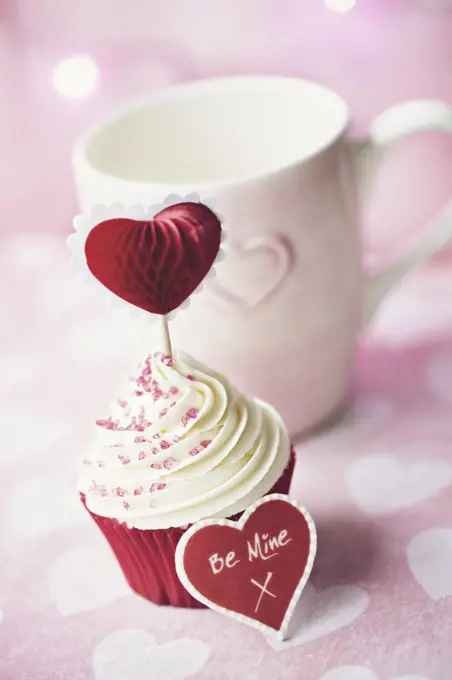 Cupcake decorated with a heart shaped cake pick