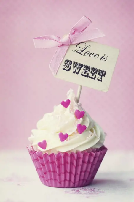 Cupcake with "love is sweet" pick